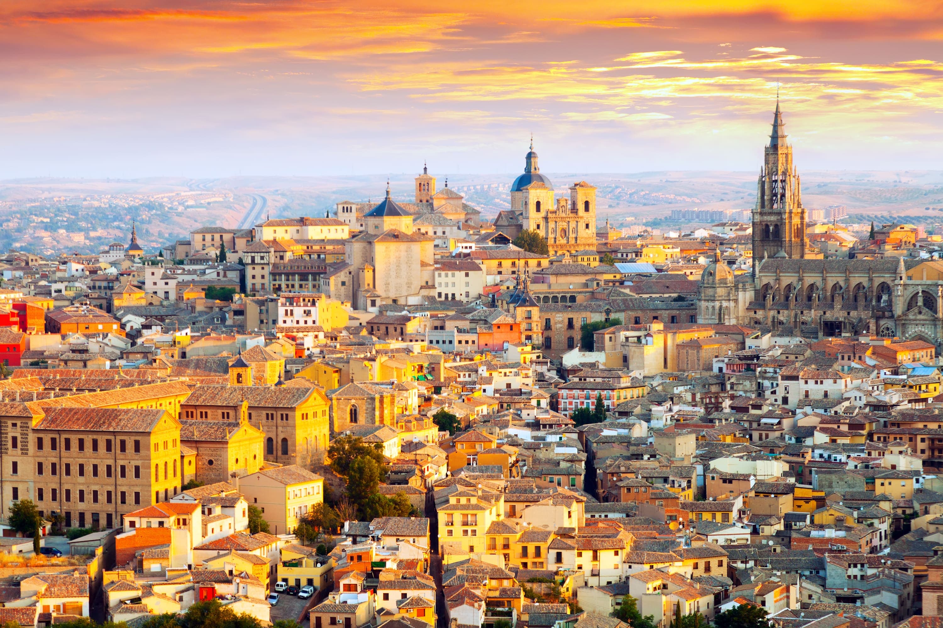 Scenic view of a historic cityscape in Spain with vibrant architecture and sunny skies.