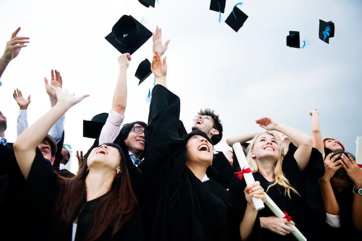 group-diverse-grads-throwing-caps-up-sky_53876-56031.avif