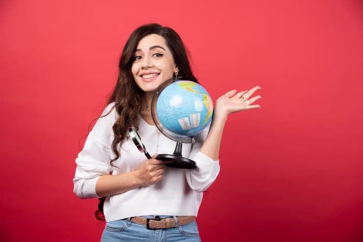 happy-woman-posing-with-globe-magnifying-glass-high-quality-photo_114579-62358.avif